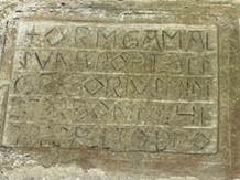 A stone with writing on it

Description automatically generated
